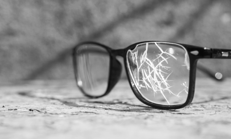 close up on broken black glasses when you don't have glasses insurance