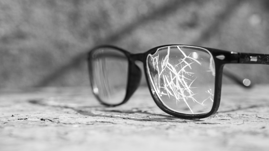 close up on broken black glasses when you don't have glasses insurance